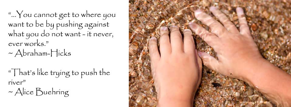 A foot submerged in clear water over small stones.